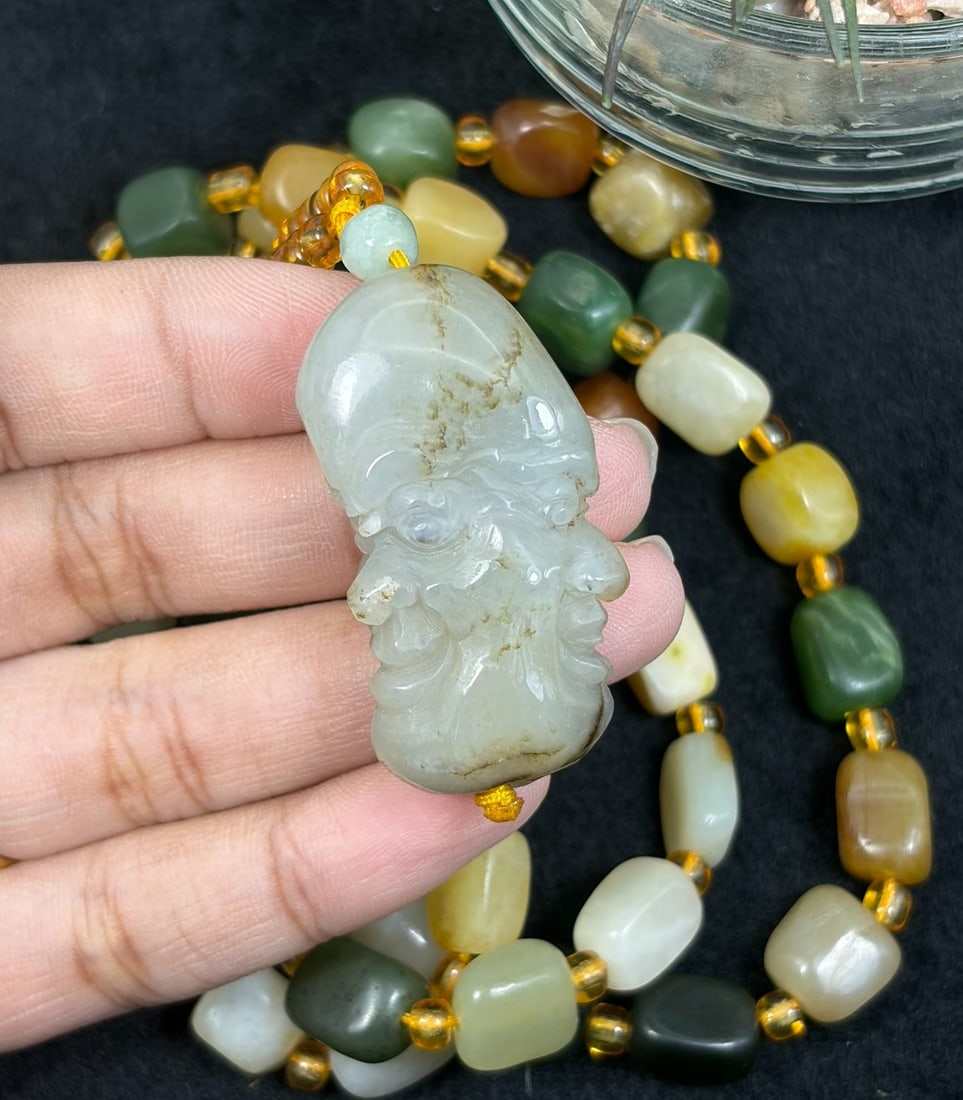 Natural Xinjiang Hetian Jade Necklace - Luohan Head Pendant, 73YJ: This necklace features a detailed natural Xinjiang Hetian jade luohan head pendant paired with matching multi-tonal Hetian jade pebble beads, accented with translucent yellow spacer beads. The pendant