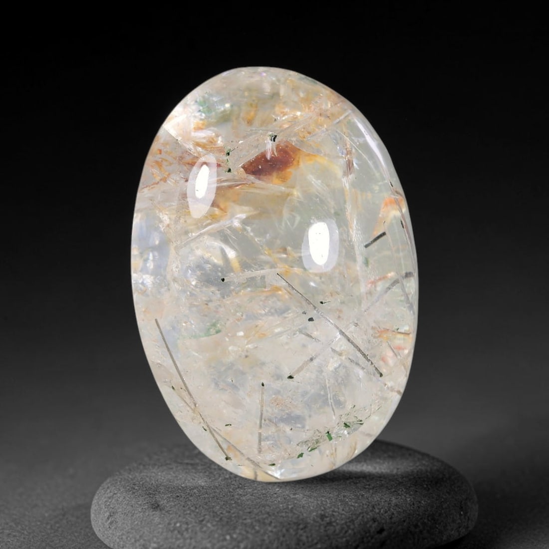 29.06ct Natural Brazilian Black Rutile Quartz Cabochon Loose Gemstone, 19YX: This polished cabochon of natural rutile quartz features countless distinct slender black rutile needle inclusions suspended within the clear quartz host crystal. The smooth domed surface enables full