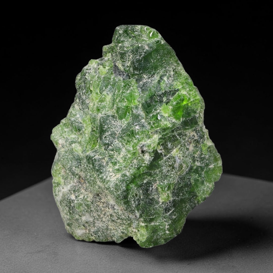 46 Carats Natural Vibrant Green Chrome Diopside Rough Specimen, 35YS: This is an untreated natural chrome diopside mineral specimen formed through natural geological processes, displaying rich green coloration caused by chromium content within its crystalline structure.