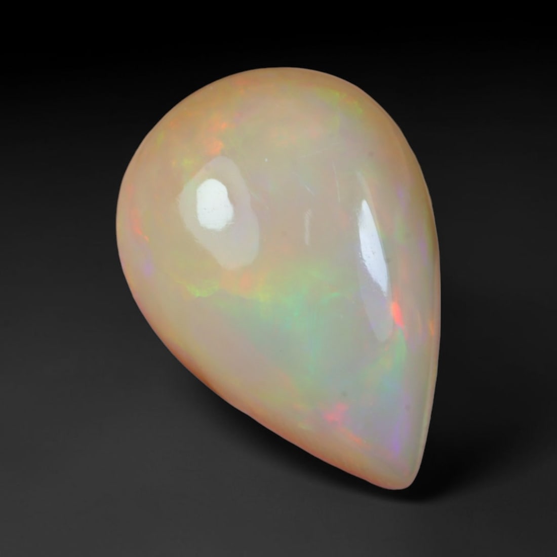 3.84 Carats Natural Ethiopian Welo Opal Oval Cabochon Loose Gemstone, 56XV: Natural Ethiopian Welo opal polished oval cabochon loose gemstone, luminous translucent milky white base stone with vivid multi-hued play-of-color featuring bright emerald green, lime yellow, soft blu