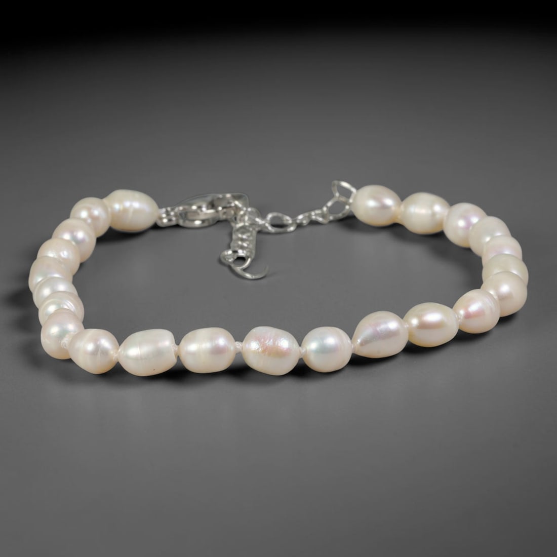 Natural Freshwater Pearl Bracelet - Slim Baroque Milky White Pearl Strand, 69YM: Crafted from petite organic baroque natural freshwater pearls with gentle milky white pearlescent iridescence, each bead features slim asymmetrical barrel and oval silhouettes formed through natural p
