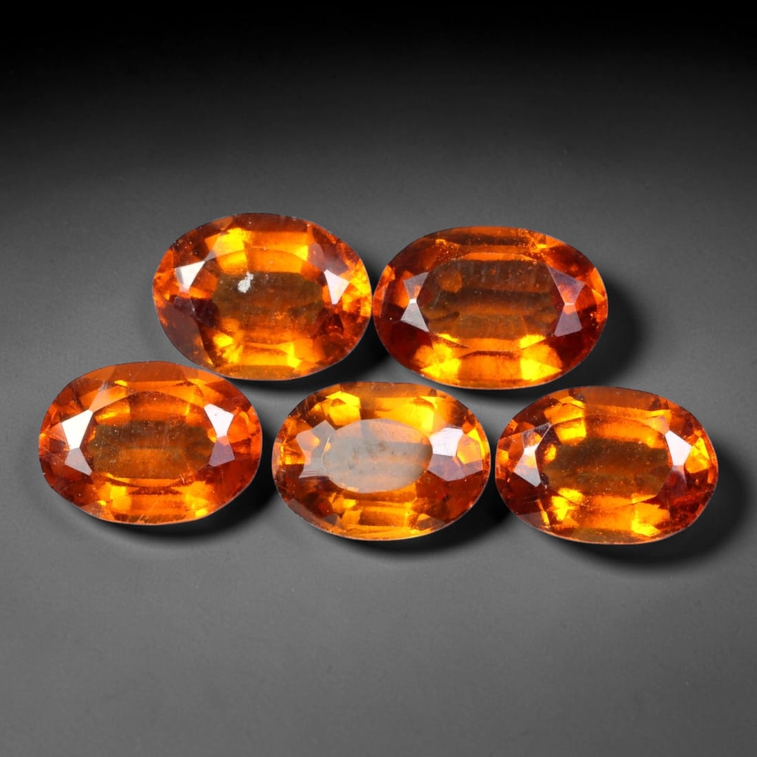 5.77ct Natural Hessonite Garnet Oval Faceted Parcel Loose Gemstone, 96XX: Matching parcel of hand faceted natural hessonite garnet gemstones featuring rich warm orange-brown hue with subtle inherent mineral characteristics within each stone. Precision faceting and glossy hi