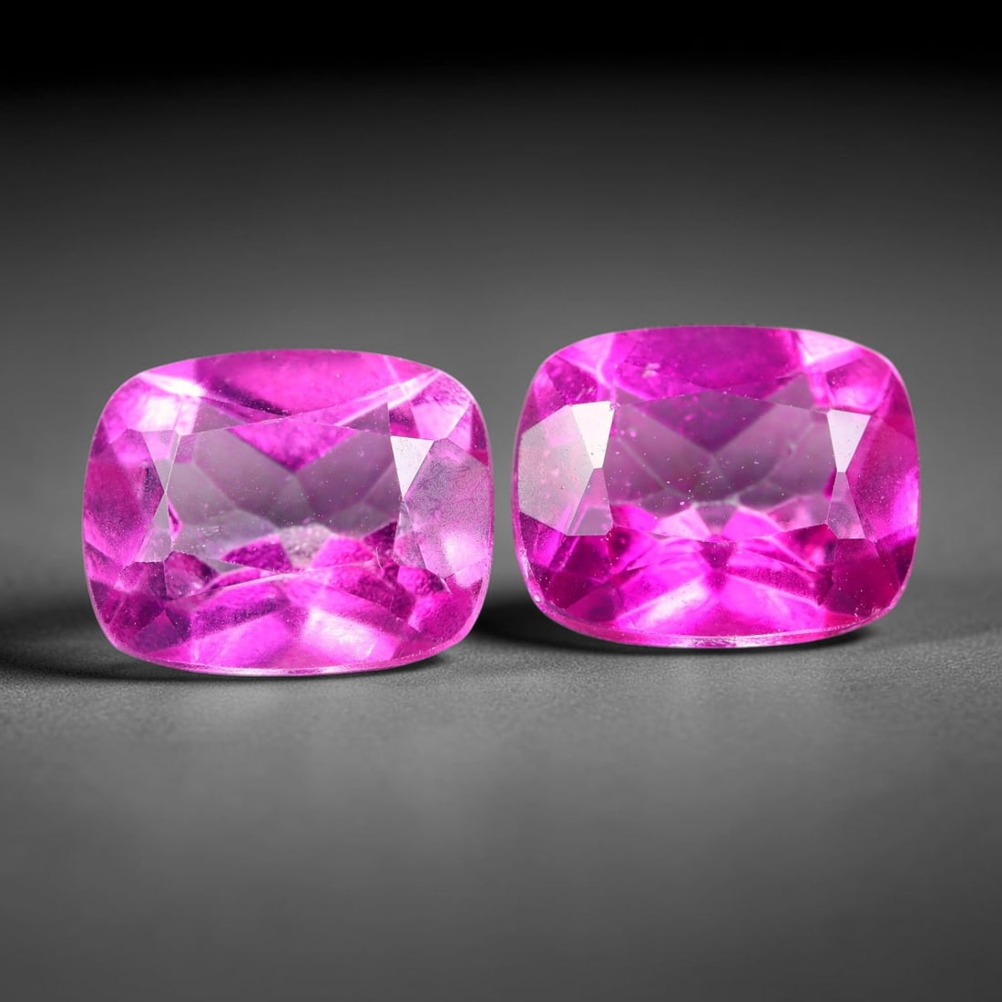 7.19ct Natural Pink Topaz Cushion Cut Matched Pair Loose Gemstones, 92TG: Natural pink topaz fashioned into a matched pair of cushion mixed cuts with polished table and brilliant pavilion facets. The stones display a saturated vivid hot pink body color with excellent transp