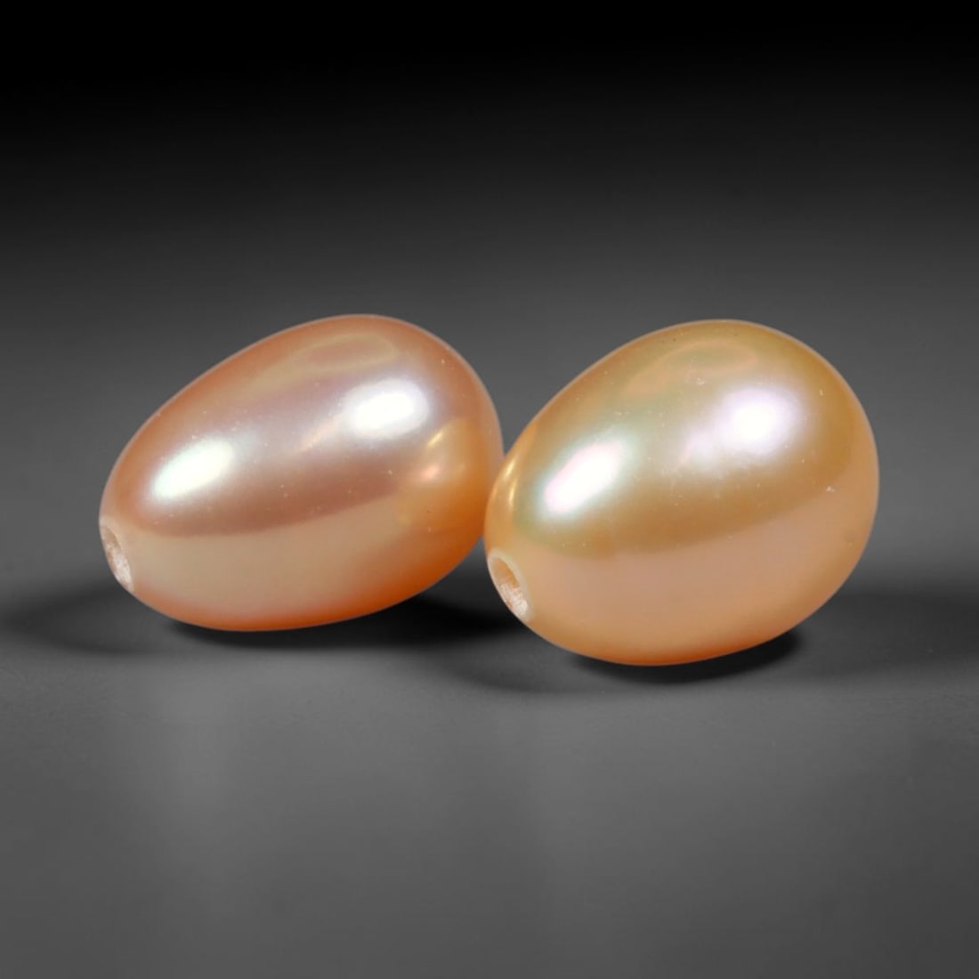 4.05ct Natural Peach Golden Orient Freshwater Egg Shape Pearl Pair, 60XZ: Matched pair of natural freshwater egg/oval pearls, uniform 7.9x7.2mm with clean through-drilled holes ready for jewelry setting. Each pearl features smooth silky nacre with a soft warm peach-gold bas
