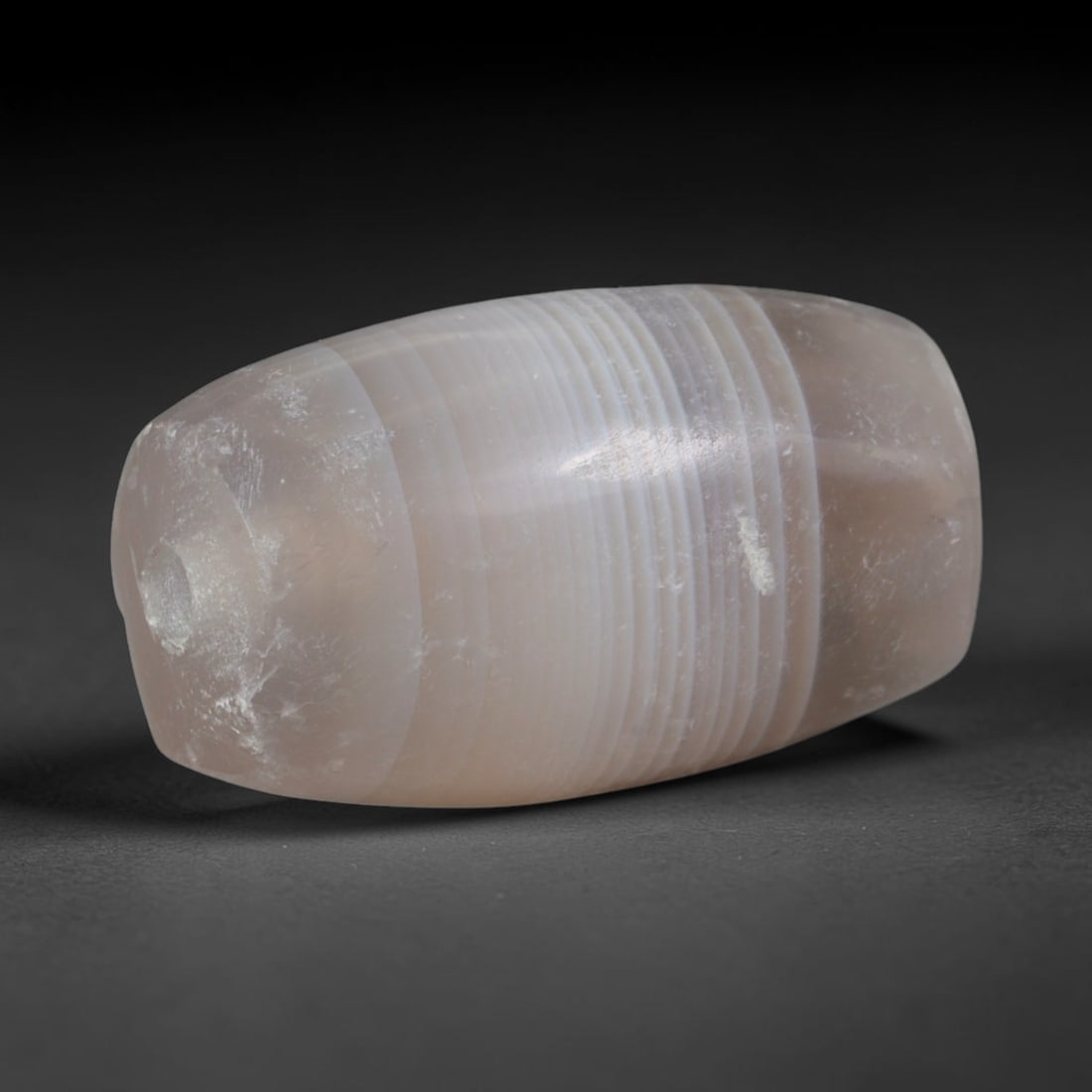 Ancient Han Dynasty Banded Agate Barrel Bead (202 BCE-220 CE), 97XD: This antique banded agate barrel bead originates from the Han Dynasty, a pivotal East Asian civilization that established large-scale domestic agate carving and traded polished banded chalcedony beads