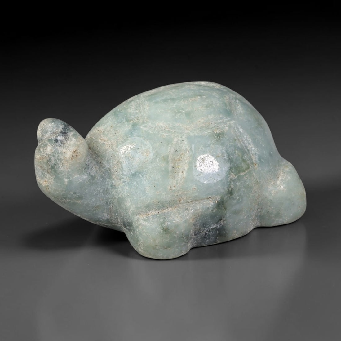 Natural Burmese Type A Light Mottled Celadon Jadeite Jade Turtle Carving, 99TC: Hand-carved from natural Burmese Type A jadeite, this turtle figurine measures 31x22.8mm. It features soft celadon green with scattered darker green clouding and faint surface patina, with subtle carv