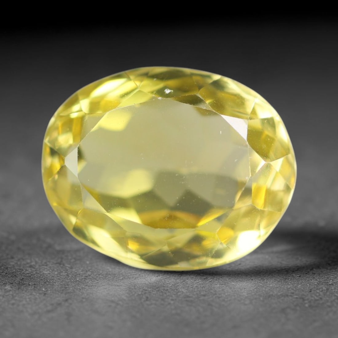 10.57 Carats Natural Brazilian Lemon Quartz Oval Faceted Loose Gemstone, 7XX: This lemon quartz is sourced from natural mineral deposits within Brazil and refined through standard professional faceted lapidary procedures, accompanied by uniform glossy polishing across the full 