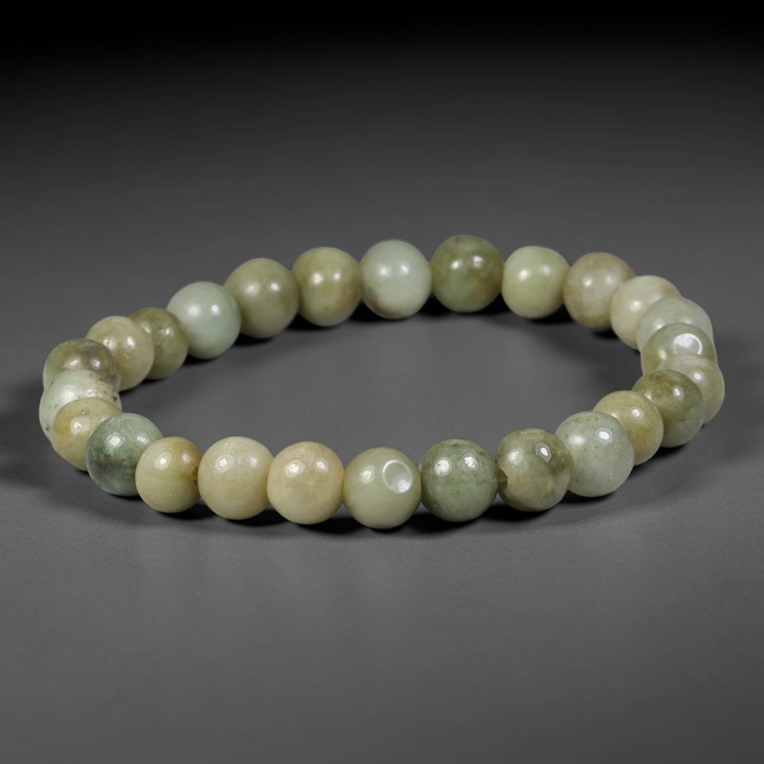 Natural Burmese Type A Muted Celadon Jadeite Jade Beaded Bracelet, 65TA: Handcrafted from 100% untreated authentic Burmese Type A jadeite, this bracelet features uniformly polished smooth round beads with soft muted celadon base tones blended with natural earthy yellow and