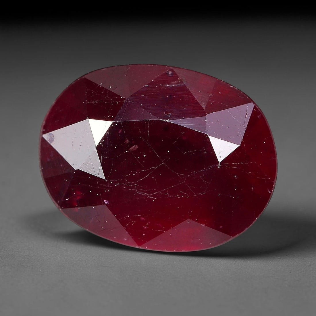 3.41 Carats Natural Madagascar Ruby Oval Faceted Loose Gemstone, 30TM: This sizable natural Madagascar ruby is cut into an oval brilliant faceted form, showcasing rich saturated crimson red hue characteristic of Malagasy corundum. Extensive natural internal silk veining,