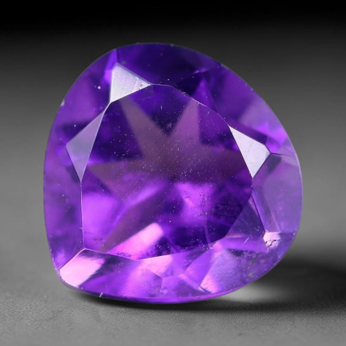 4.10ct Natural Brazilian Purple Amethyst Pear Faceted Gemstone, 59YW: This faceted gemstone is composed of natural Brazilian amethyst, cut in a pear shape with precise faceting to showcase the saturated purple hue. The stone displays natural internal inclusions consiste