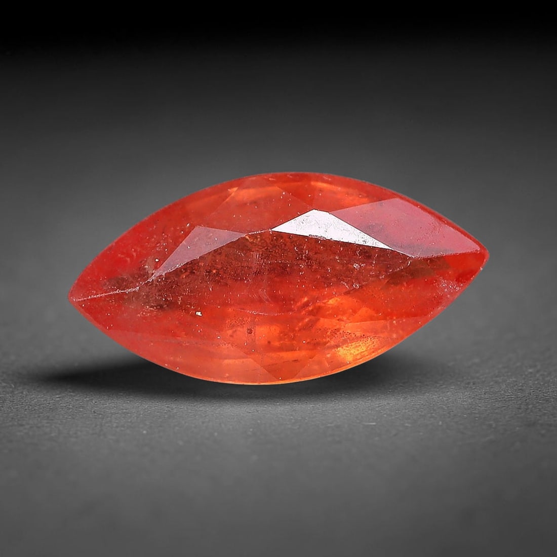 0.66ct Natural Orange Red Sapphire Marquise Faceted Loose Gemstone, 70YW: This faceted gemstone consists of natural sapphire, cut in a marquise shape with polished facets that showcase its orange red colouration. Natural internal inclusions and surface characteristics are v