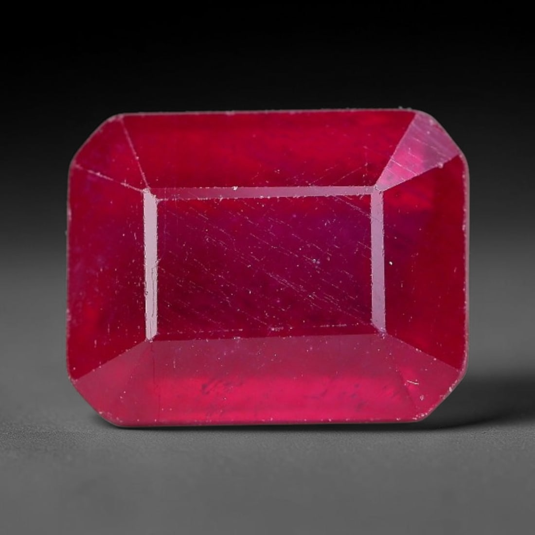5.94 Carats Natural Madagascar Ruby Emerald Cut Loose Gemstone, 14YW: This natural Madagascar ruby is fashioned in a traditional emerald step faceted cut, showcasing deep saturated red tones typical of Malagasy corundum. Distinct natural internal fissures, fine mineral 
