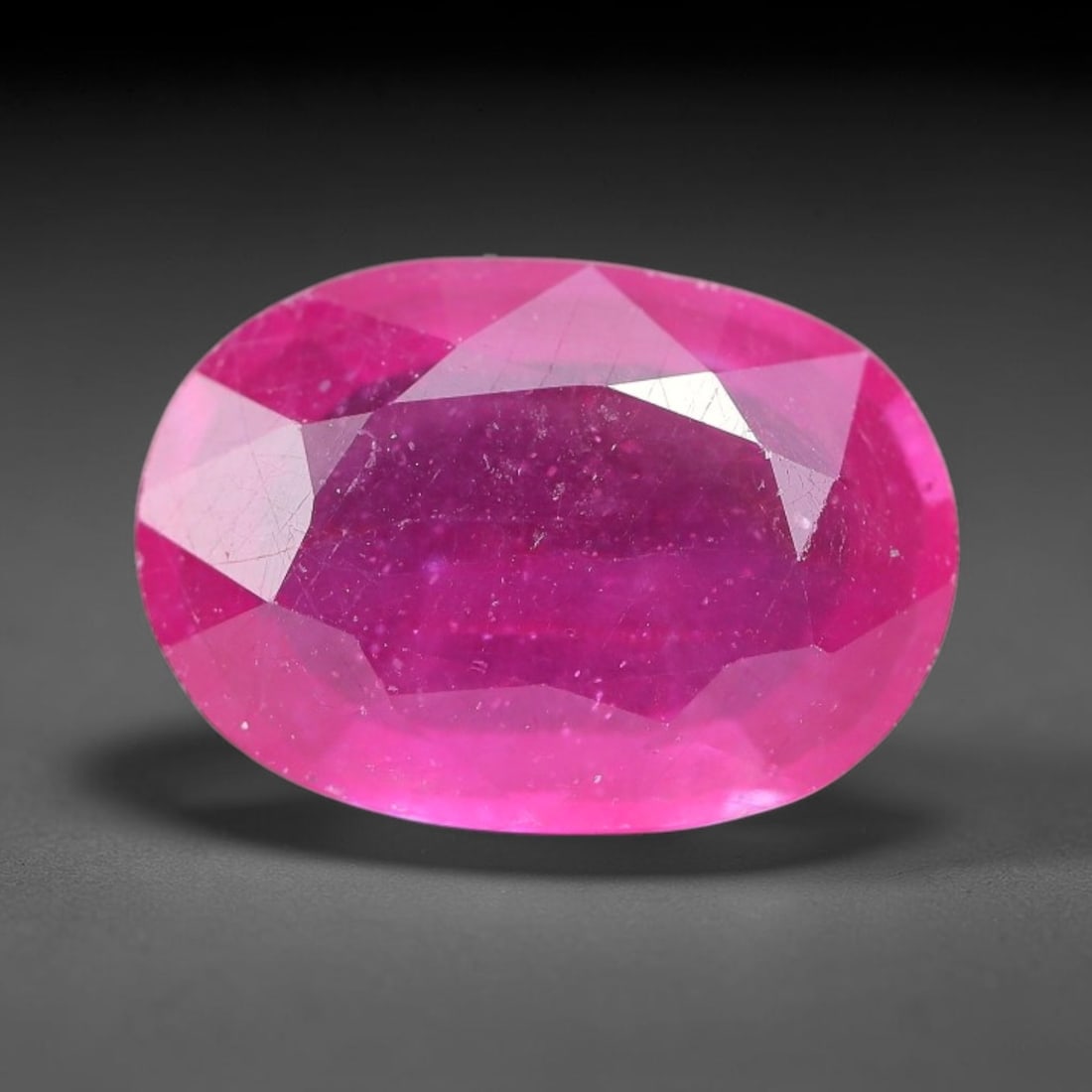 5.19 Carats Natural Madagascar Ruby Oval Faceted Loose Gemstone, 80TM: This sizable natural Madagascar ruby is cut into an oval brilliant faceted form, showcasing rich saturated crimson red hue characteristic of Malagasy corundum. Extensive natural internal silk veining,