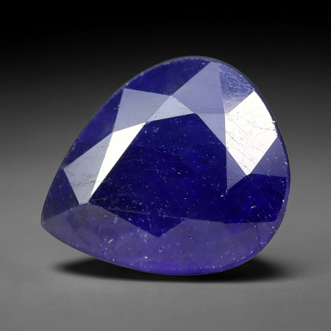 5.07 Carats Royal Blue Sapphire Pear Faceted Loose Gemstone, 93TM: This classic pear faceted sapphire displays rich saturated royal blue color glowing through crisp polished multi-facet cuts, featuring natural fine internal fissures and tiny scattered mineral micro s