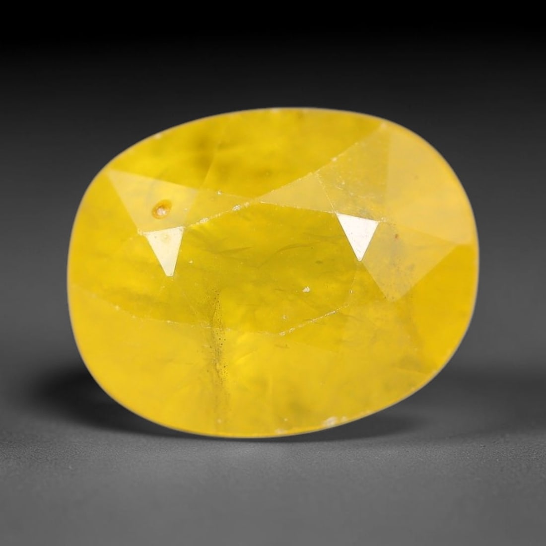 2.11 Carats Natural Yellow Sapphire Oval Faceted Loose Gemstone, 38YW: This natural yellow sapphire features a classic oval brilliant faceted cut, holding consistent warm golden-yellow color throughout the corundum crystal. Fine microscopic mineral specks and faint natur