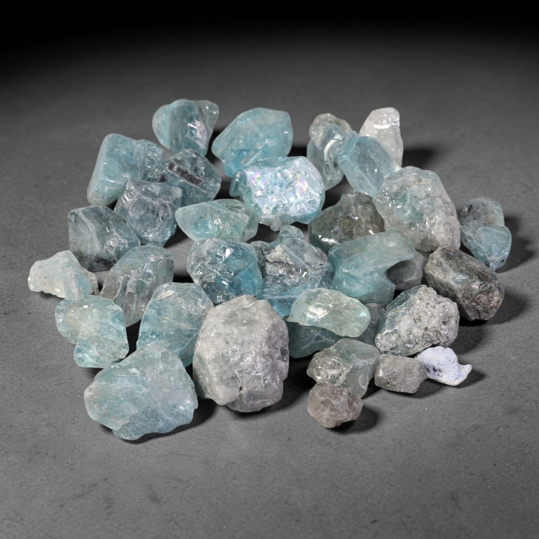 228.19ct Natural Cambodian Blue Zircon Rough Parcel Loose Gemstone, 87YT: This parcel consists of natural unpolished blue zircon rough crystals with translucent sky-blue to teal hues, featuring natural crystalline textures and facets. Minor matrix and inclusions are visible