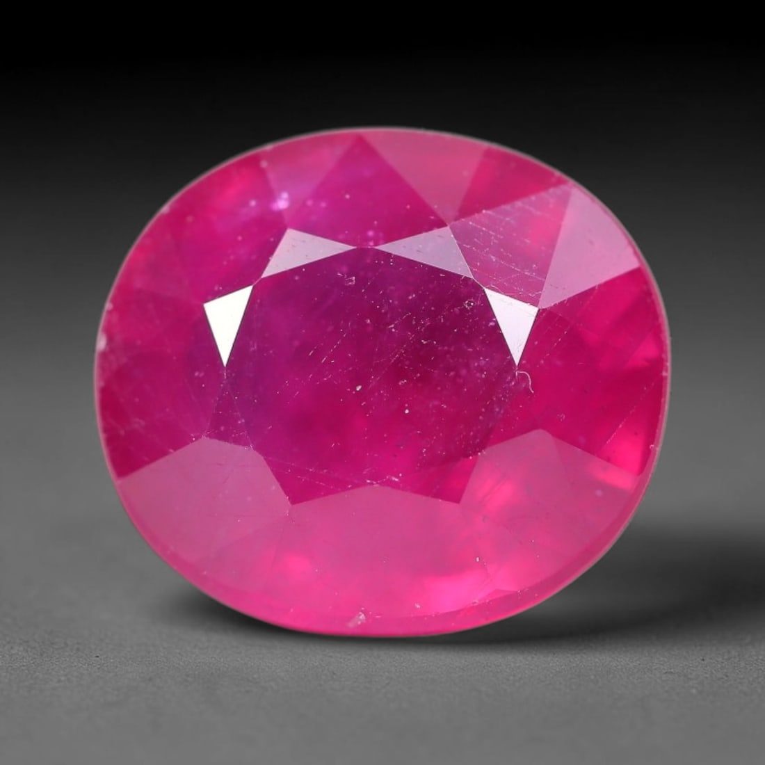 13.50 Carats Natural Madagascar Ruby Oval Faceted Loose Gemstone, 72TM: This sizable natural Madagascar ruby is cut into an oval brilliant faceted form, showcasing rich saturated crimson red hue characteristic of Malagasy corundum. Extensive natural internal silk veining,