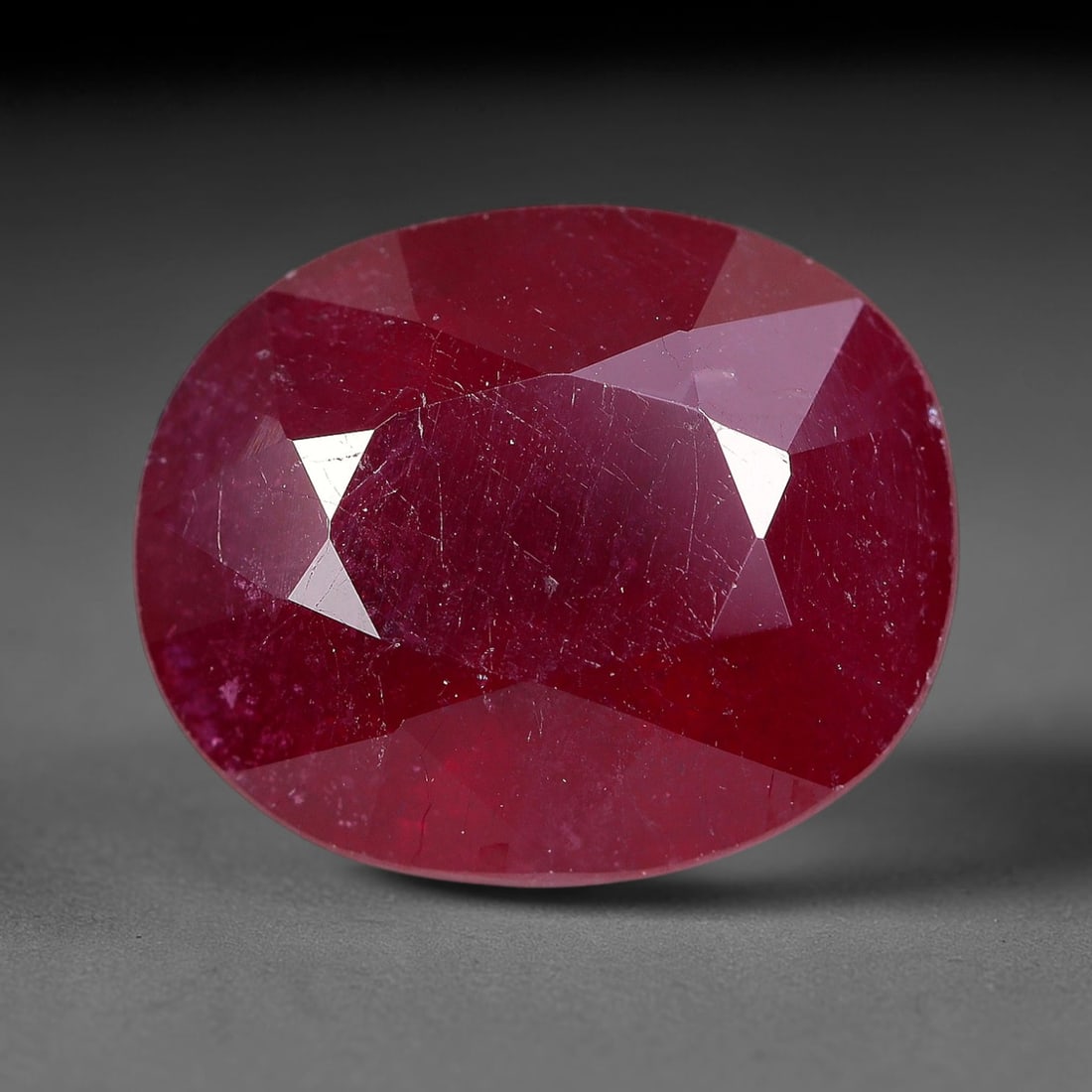 5.72 Carats Natural Madagascar Ruby Oval Faceted Loose Gemstone, 34TM: This sizable natural Madagascar ruby is cut into an oval brilliant faceted form, showcasing rich saturated crimson red hue characteristic of Malagasy corundum. Extensive natural internal silk veining,