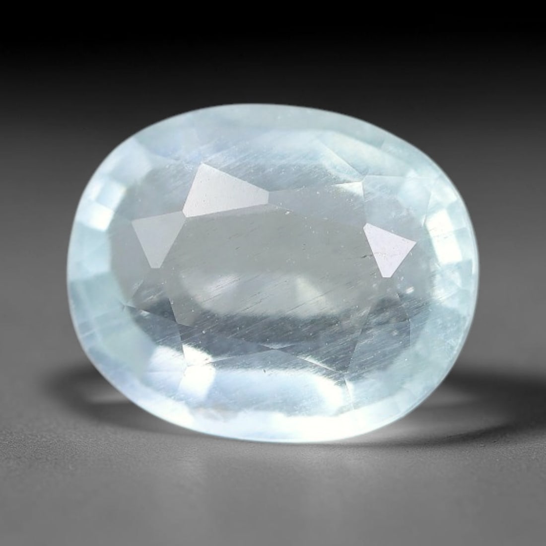 2.09ct Natural Pale Blue Aquamarine Oval Faceted Gemstone, 10YW: This faceted gemstone is natural aquamarine, cut in an oval form with polished facets displaying its soft pale blue hue. Visible natural internal features occur within the crystal, consistent with unt