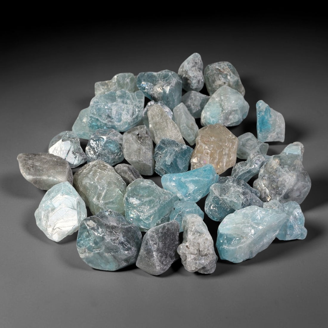 250.29ct Natural Cambodian Blue Zircon Rough Parcel Loose Gemstone, 71YT: This parcel consists of natural unpolished blue zircon rough crystals with translucent sky-blue to teal hues, featuring natural crystalline textures and facets. Minor matrix and inclusions are visible