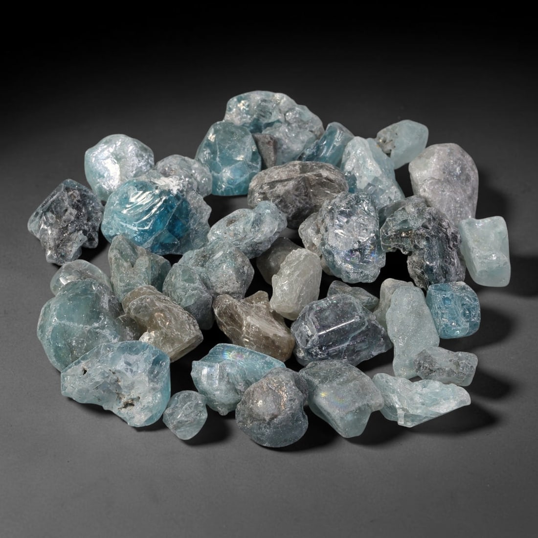 246.81ct Natural Cambodian Blue Zircon Rough Parcel Loose Gemstone, 88YT: This parcel consists of natural unpolished blue zircon rough crystals with translucent sky-blue to teal hues, featuring natural crystalline textures and facets. Minor matrix and inclusions are visible