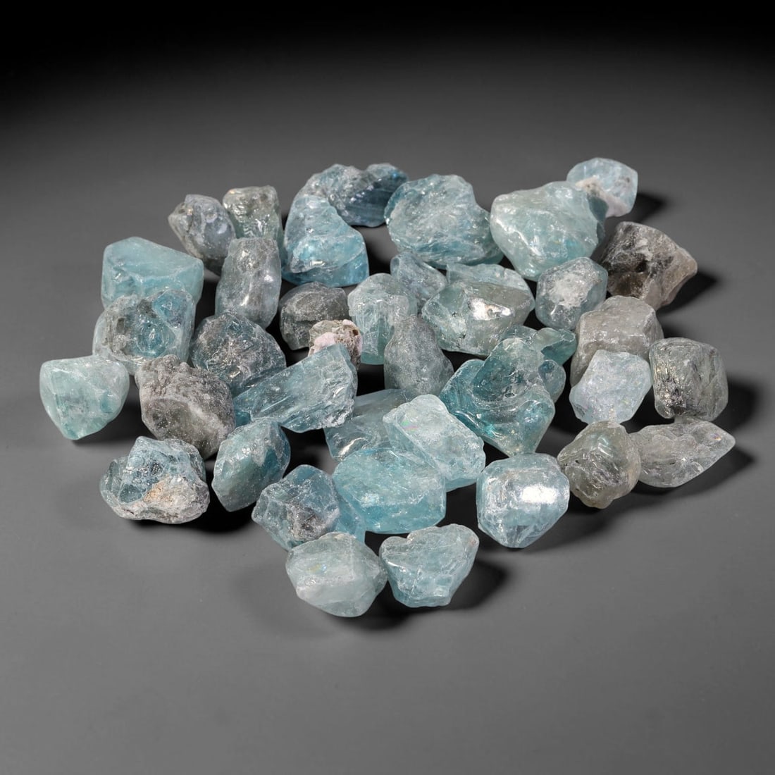 261.49ct Natural Cambodian Blue Zircon Rough Parcel Loose Gemstone, 80YT: This parcel consists of natural unpolished blue zircon rough crystals with translucent sky-blue to teal hues, featuring natural crystalline textures and facets. Minor matrix and inclusions are visible