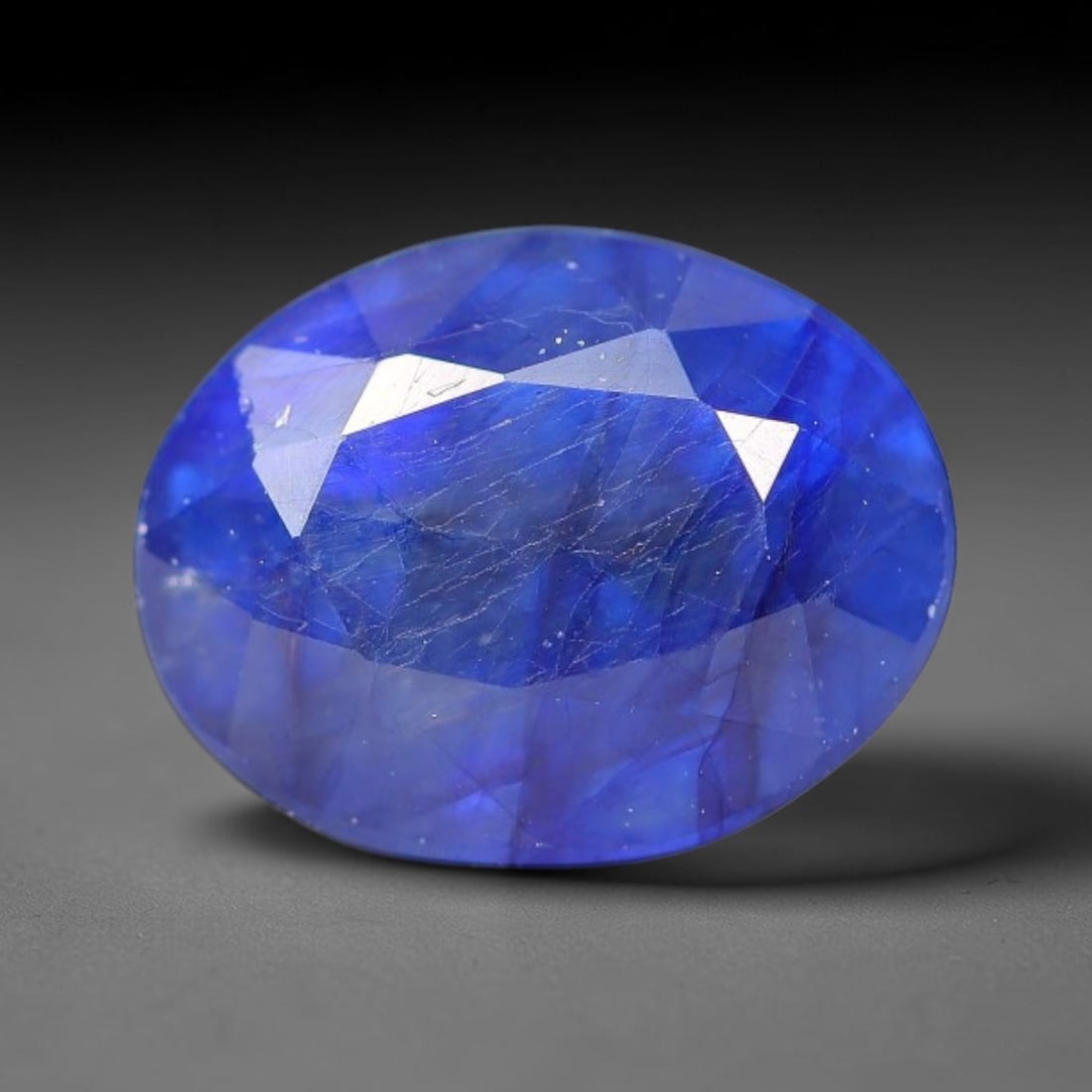 3.45 Carats Royal Blue Sapphire Oval Faceted Loose Gemstone, 2YW: This classic oval faceted sapphire displays rich saturated royal blue color glowing through crisp polished multi-facet cuts, featuring natural fine internal fissures and tiny scattered mineral micro s