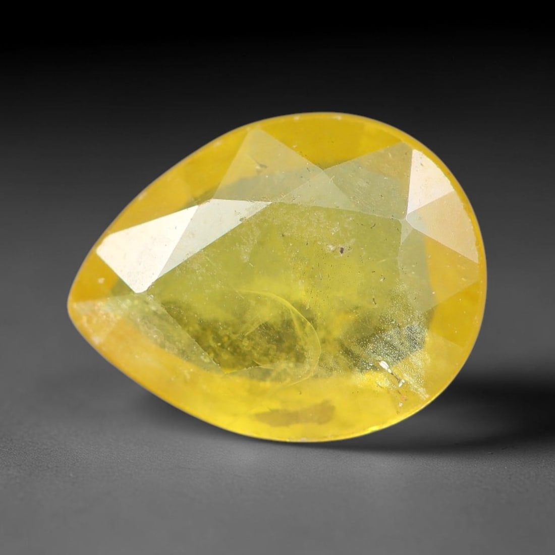 1.46 Carats Natural Yellow Sapphire Pear Faceted Loose Gemstone, 36YW: This natural yellow sapphire features a classic pear brilliant faceted cut, holding consistent warm golden-yellow color throughout the corundum crystal. Fine microscopic mineral specks and faint natur