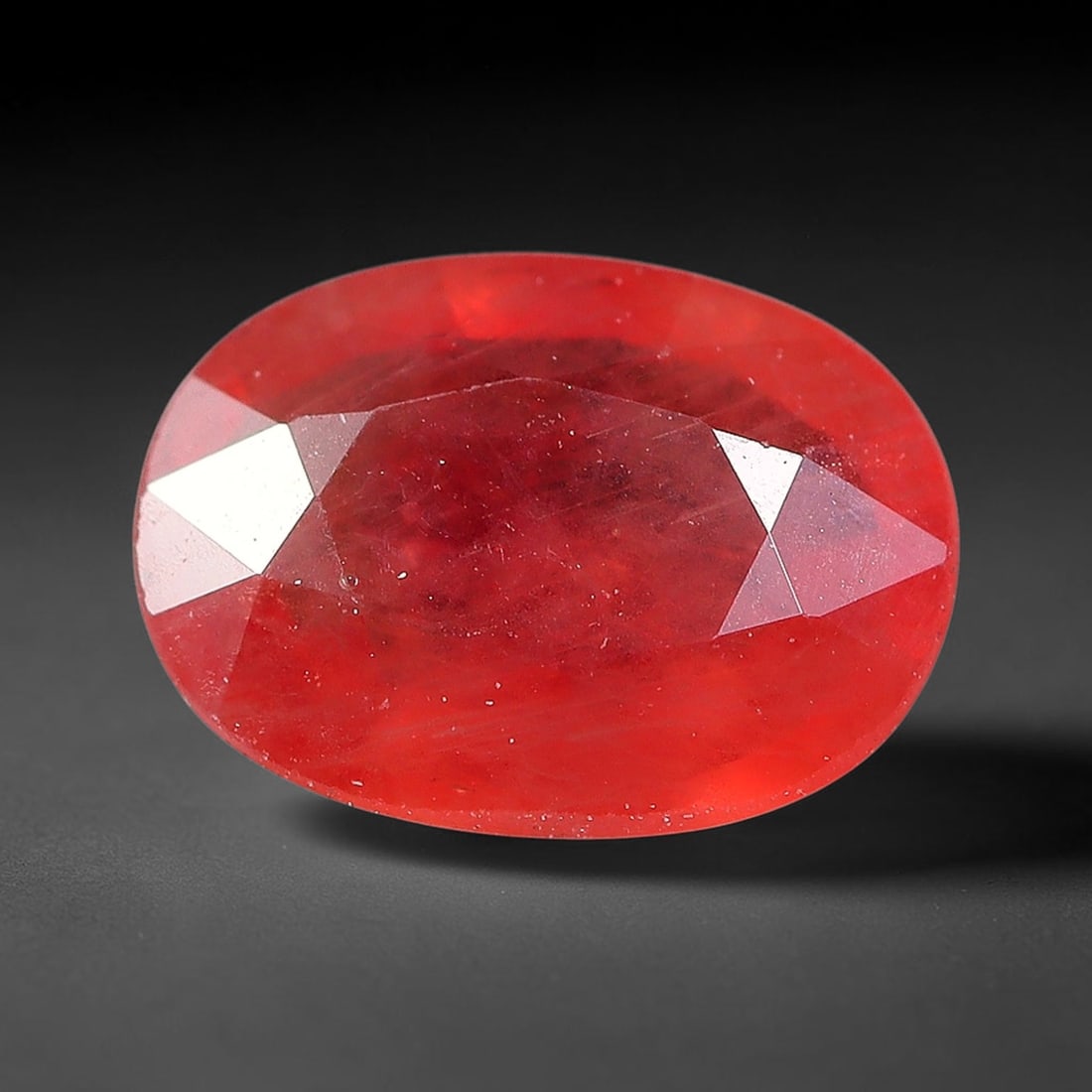 0.93ct Natural Orange Red Sapphire Oval Faceted Loose Gemstone, 72YW: This faceted gemstone consists of natural sapphire, cut in a oval shape with polished facets that showcase its orange red colouration. Natural internal inclusions and surface characteristics are visib