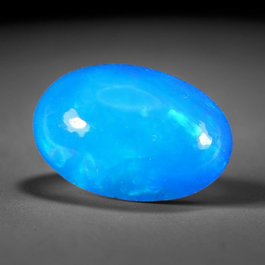 3.11ct Natural Ethiopian Welo Blue Fire Opal Cabochon Loose Gemstone, 96TH: This opal is sourced from Ethiopian Welo natural opal deposits and shaped into a smooth polished cabochon form with refined lapidary finishing work. Bright warm blue base accompanied by vivid internal