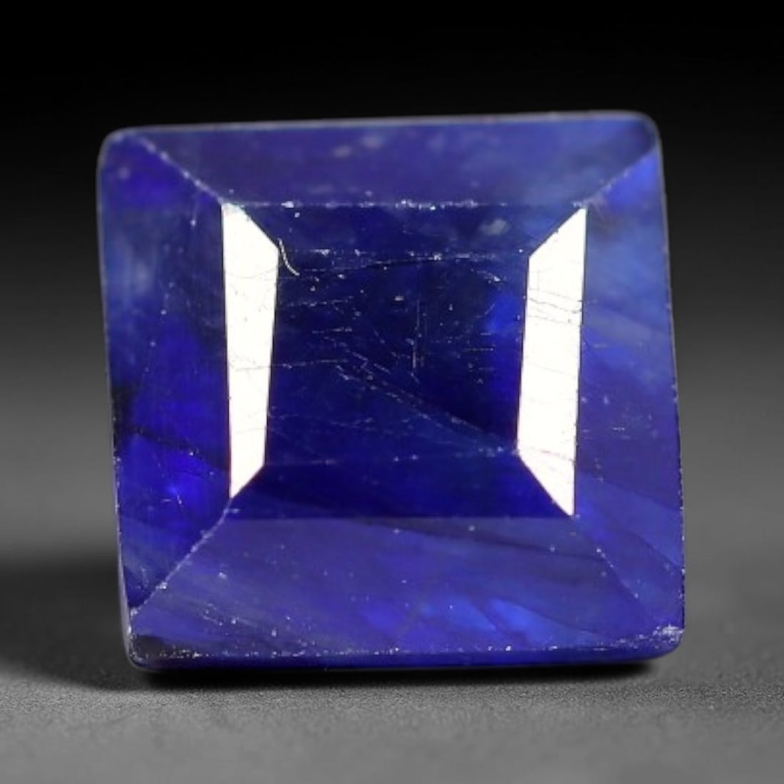 1.65 Carats Royal Blue Sapphire Square Cushion Faceted Loose Gemstone, 100TS: This classic square cushion modified step cut faceted sapphire displays rich saturated royal blue color glowing through crisp polished multi-facet cuts, featuring natural fine internal fissures and ti