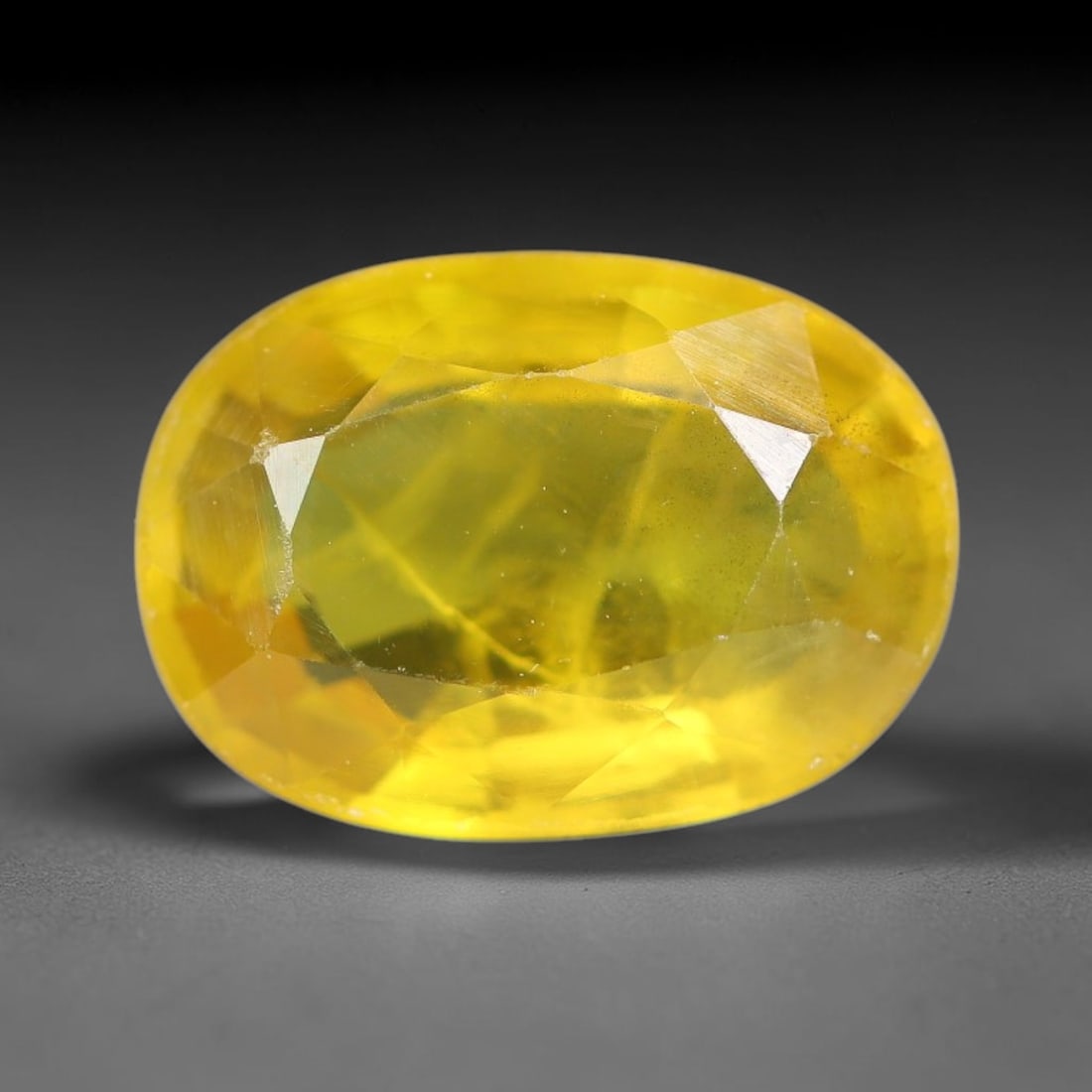 2.47 Carats Natural Yellow Sapphire Oval Faceted Loose Gemstone, 54YW: This natural yellow sapphire features a classic oval brilliant faceted cut, holding consistent warm golden-yellow color throughout the corundum crystal. Fine microscopic mineral specks and faint natur