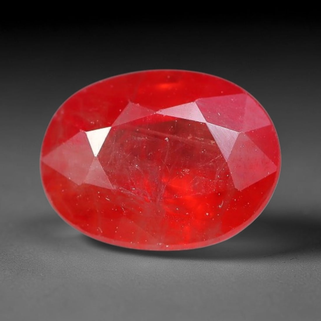 1.30ct Natural Orange Red Sapphire Oval Faceted Loose Gemstone, 78YW: This faceted gemstone consists of natural sapphire, cut in a oval shape with polished facets that showcase its orange red colouration. Natural internal inclusions and surface characteristics are visib