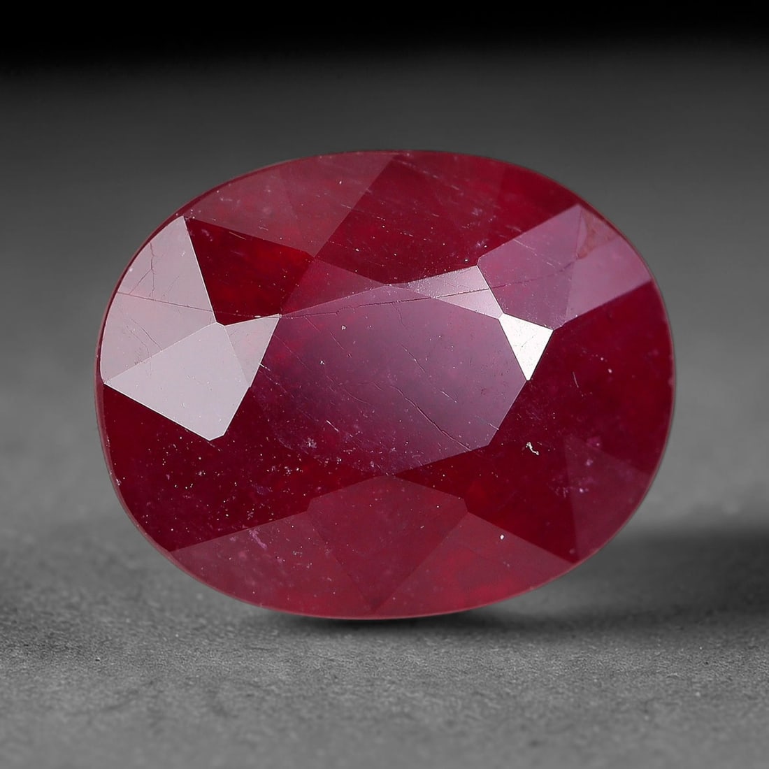 4.56 Carats Natural Madagascar Ruby Oval Faceted Loose Gemstone, 40TM: This sizable natural Madagascar ruby is cut into an oval brilliant faceted form, showcasing rich saturated crimson red hue characteristic of Malagasy corundum. Extensive natural internal silk veining,