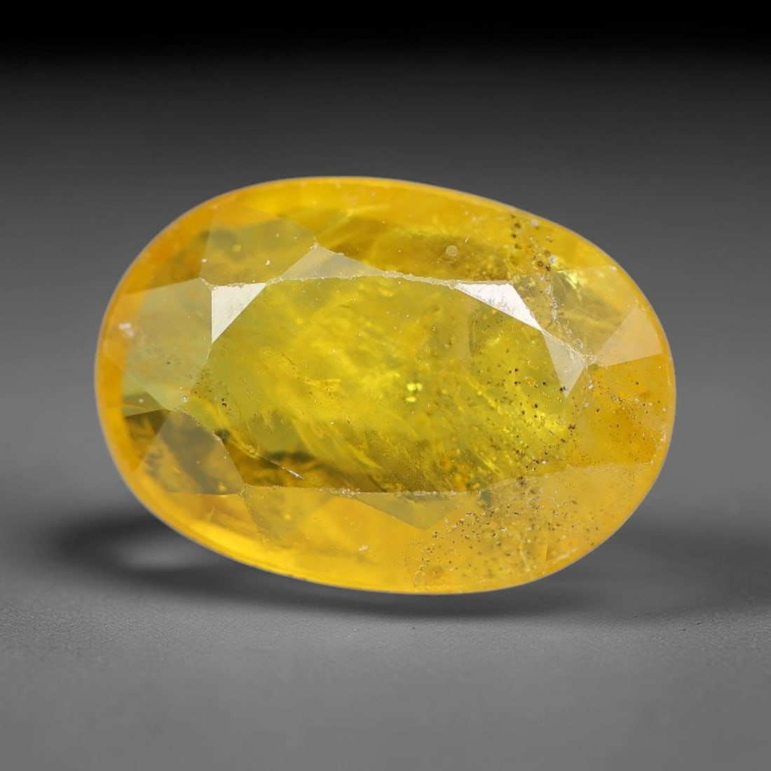1.78 Carats Natural Yellow Sapphire Oval Faceted Loose Gemstone, 51YW: This natural yellow sapphire features a classic oval brilliant faceted cut, holding consistent warm golden-yellow color throughout the corundum crystal. Fine microscopic mineral specks and faint natur