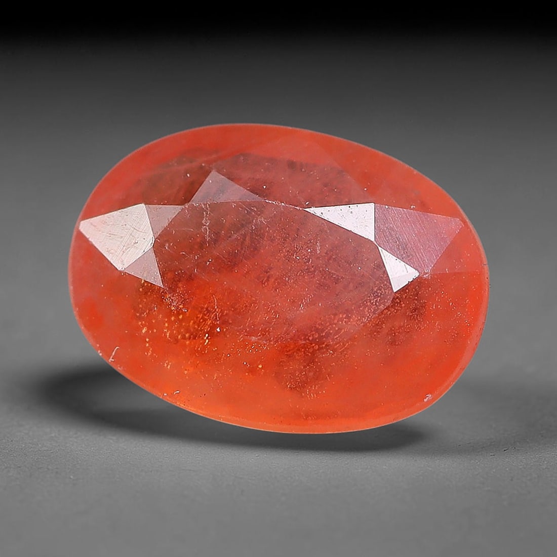 0.89ct Natural Orange Red Sapphire Oval Faceted Loose Gemstone, 73YW: This faceted gemstone consists of natural sapphire, cut in a oval shape with polished facets that showcase its orange red colouration. Natural internal inclusions and surface characteristics are visib