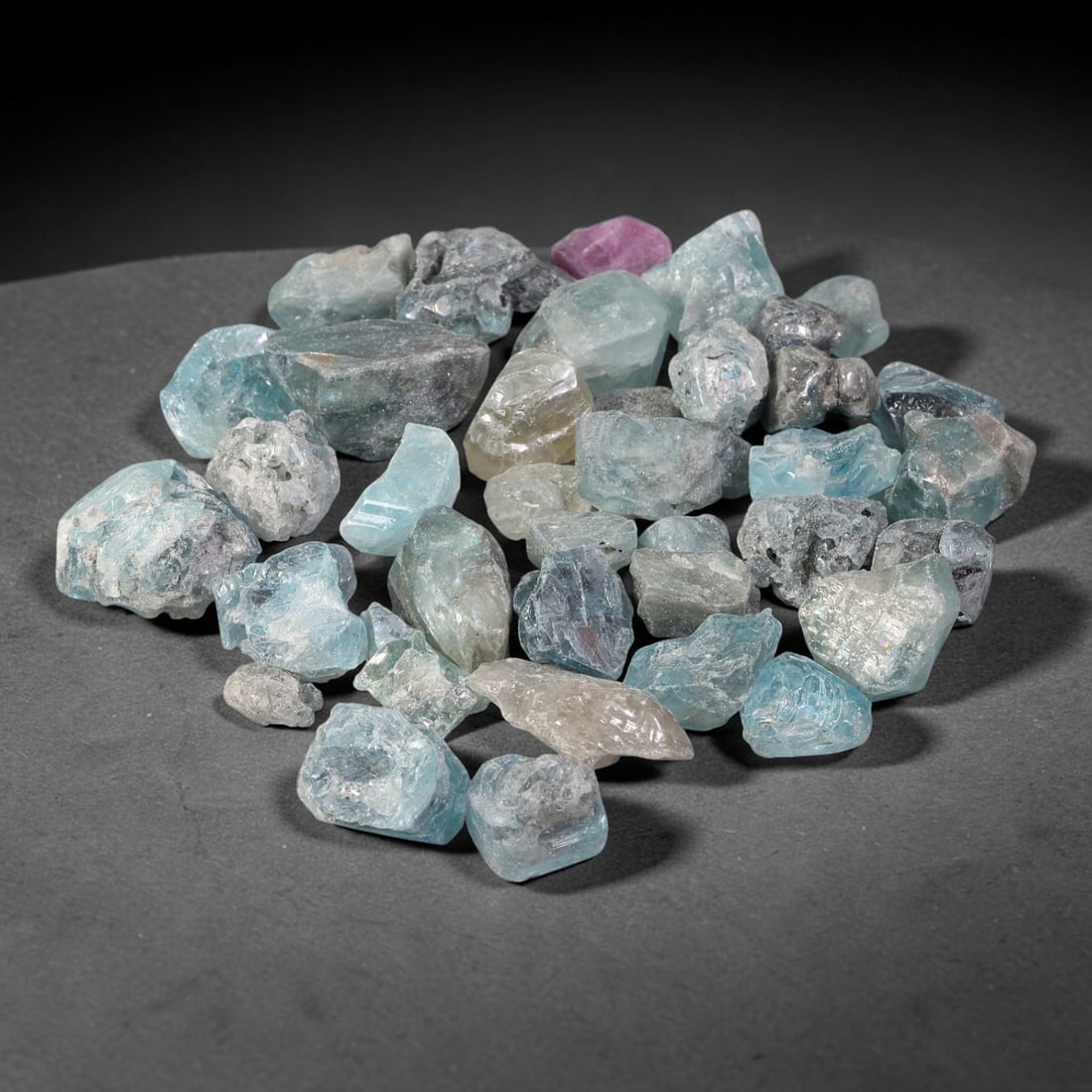 244.15ct Natural Cambodian Blue Zircon Rough Parcel Loose Gemstone, 85YT: This parcel consists of natural unpolished blue zircon rough crystals with translucent sky-blue to teal hues, featuring natural crystalline textures and facets. Minor matrix and inclusions are visible