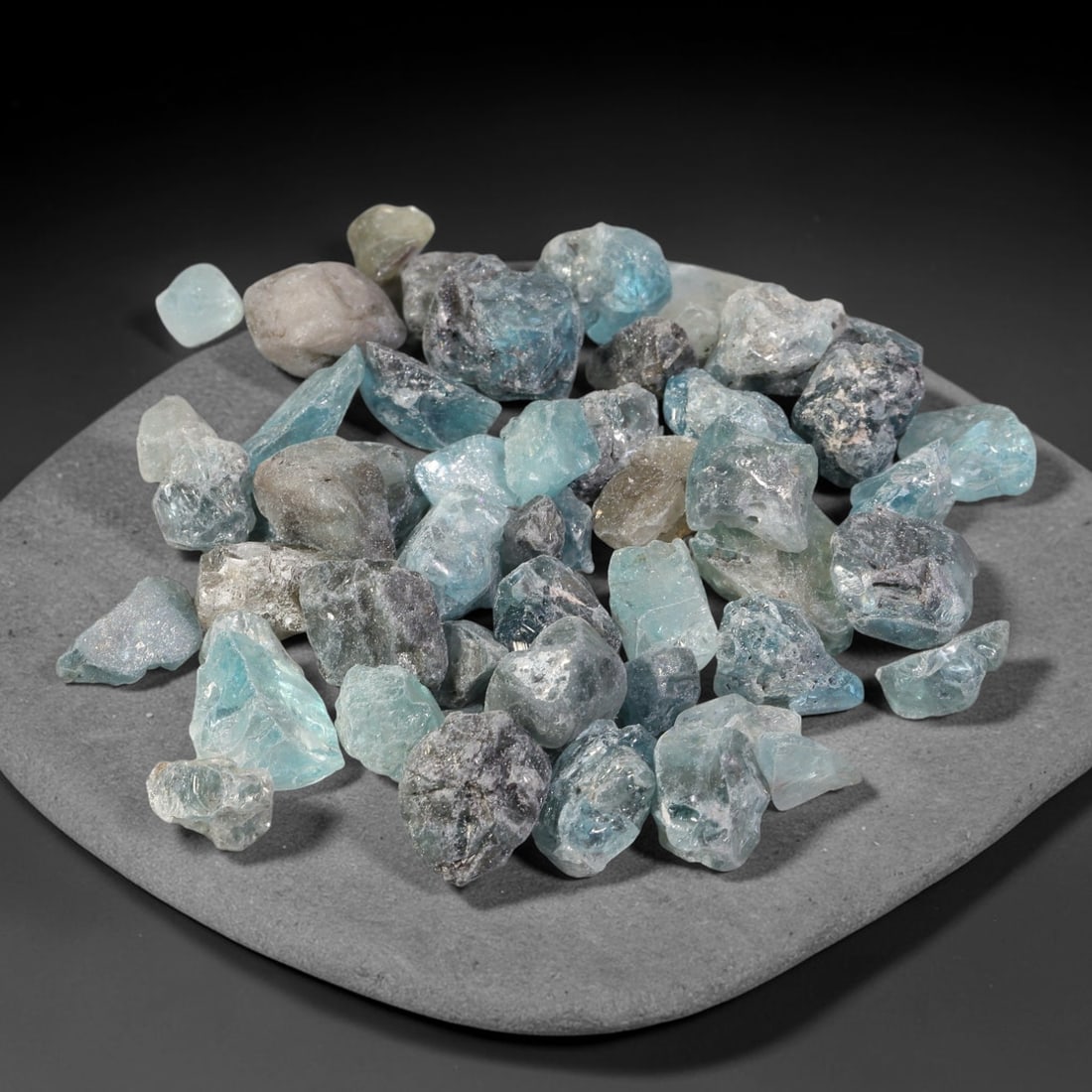 232.66ct Natural Cambodian Blue Zircon Rough Parcel Loose Gemstone, 84YT: This parcel consists of natural unpolished blue zircon rough crystals with translucent sky-blue to teal hues, featuring natural crystalline textures and facets. Minor matrix and inclusions are visible