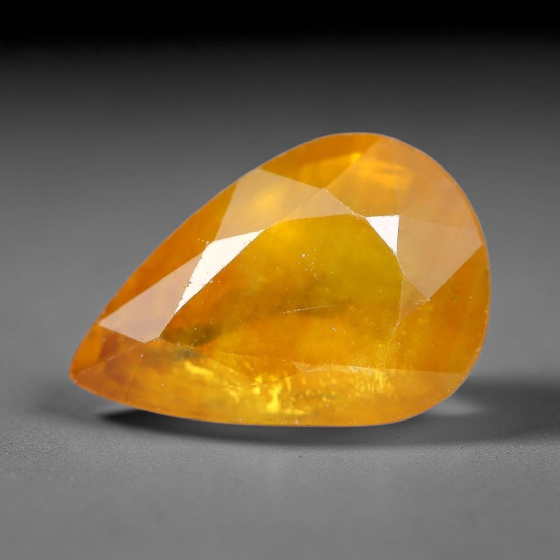 2.15 Carats Natural Yellow Sapphire Pear Faceted Loose Gemstone, 45YW: This natural yellow sapphire features a classic pear brilliant faceted cut, holding consistent warm golden-yellow color throughout the corundum crystal. Fine microscopic mineral specks and faint natur
