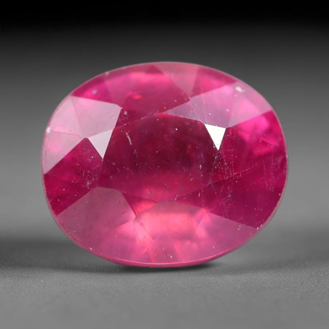 8.10 Carats Natural Madagascar Ruby Oval Faceted Loose Gemstone, 84TM: This sizable natural Madagascar ruby is cut into an oval brilliant faceted form, showcasing rich saturated crimson red hue characteristic of Malagasy corundum. Extensive natural internal silk veining,