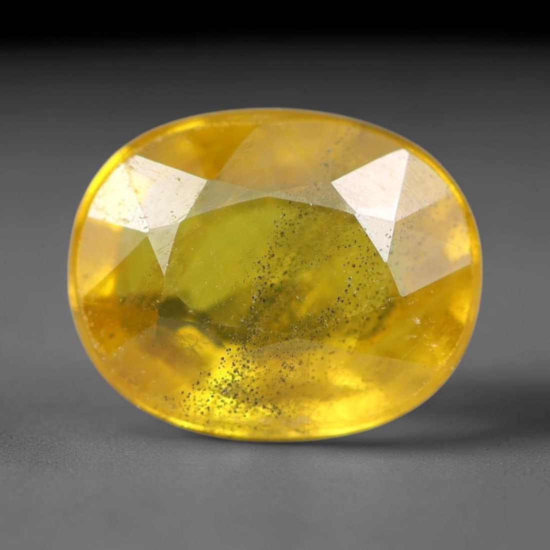 2.58 Carats Natural Yellow Sapphire Oval Faceted Loose Gemstone, 49YW: This natural yellow sapphire features a classic oval brilliant faceted cut, holding consistent warm golden-yellow color throughout the corundum crystal. Fine microscopic mineral specks and faint natur