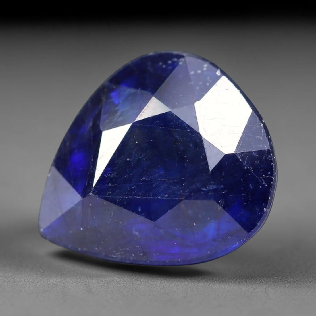 7.20 Carats Royal Blue Sapphire Pear Faceted Loose Gemstone, 92TM: This classic pear faceted sapphire displays rich saturated royal blue color glowing through crisp polished multi-facet cuts, featuring natural fine internal fissures and tiny scattered mineral micro s