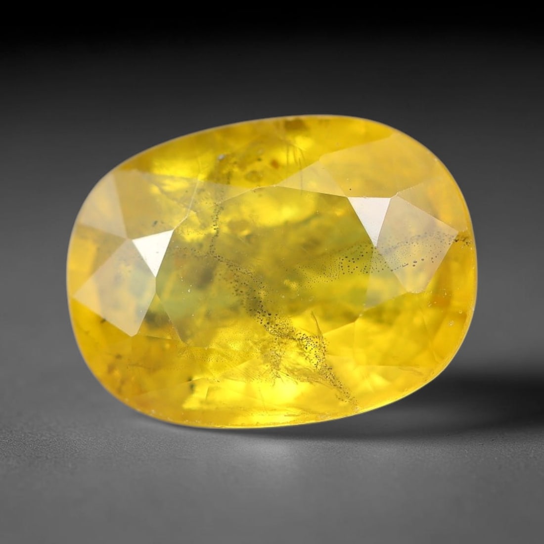2.71 Carats Natural Yellow Sapphire Oval Faceted Loose Gemstone, 41YW: This natural yellow sapphire features a classic oval brilliant faceted cut, holding consistent warm golden-yellow color throughout the corundum crystal. Fine microscopic mineral specks and faint natur