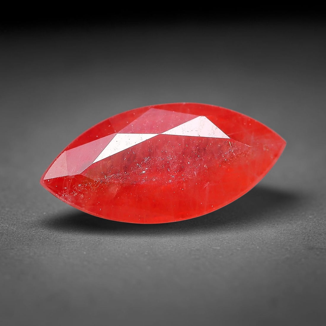 0.94ct Natural Orange Red Sapphire Marquise Faceted Loose Gemstone, 82YW: This faceted gemstone consists of natural sapphire, cut in a marquise shape with polished facets that showcase its orange red colouration. Natural internal inclusions and surface characteristics are v