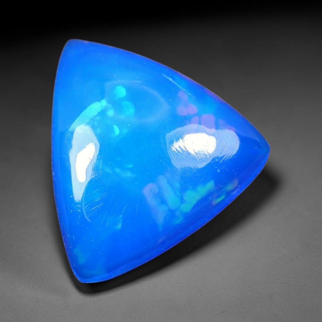 2.23ct Natural Ethiopian Welo Blue Fire Opal Cabochon Loose Gemstone, 89TS: This opal is sourced from Ethiopian Welo natural opal deposits and shaped into a smooth polished cabochon form with refined lapidary finishing work. Bright warm blue base accompanied by vivid internal