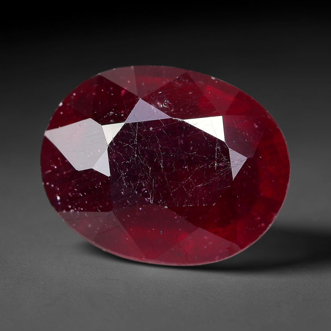 3.80 Carats Natural Madagascar Ruby Oval Faceted Loose Gemstone, 24TM: This sizable natural Madagascar ruby is cut into an oval brilliant faceted form, showcasing rich saturated crimson red hue characteristic of Malagasy corundum. Extensive natural internal silk veining,
