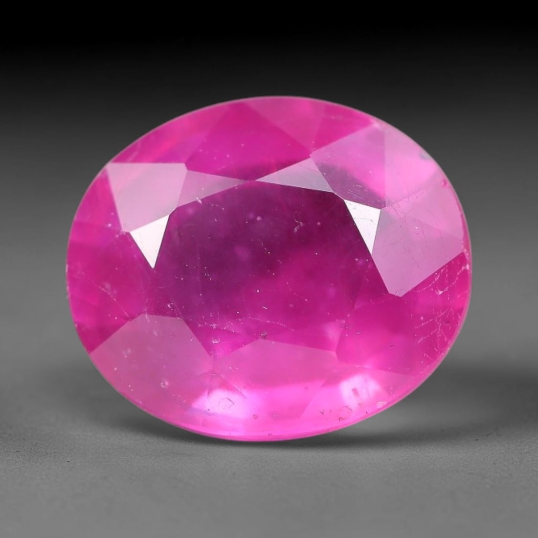 7.63 Carats Natural Madagascar Ruby Oval Faceted Loose Gemstone, 69TM: This sizable natural Madagascar ruby is cut into an oval brilliant faceted form, showcasing rich saturated crimson red hue characteristic of Malagasy corundum. Extensive natural internal silk veining,
