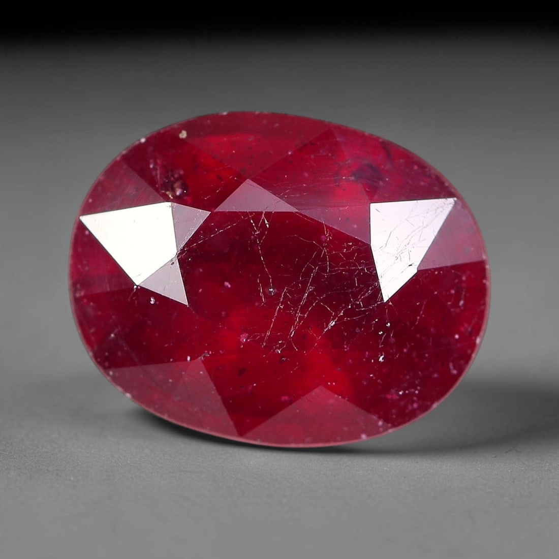 2.56 Carats Natural Madagascar Ruby Oval Faceted Loose Gemstone, 26TM: This sizable natural Madagascar ruby is cut into an oval brilliant faceted form, showcasing rich saturated crimson red hue characteristic of Malagasy corundum. Extensive natural internal silk veining,