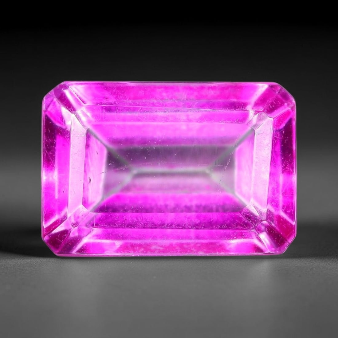 4.85 Carats Natural Brazilian Pink Topaz Faceted Emerald Cut Loose Gemstone, 11TM: This specimen is composed of natural topaz sourced from Brazilian mineral deposits, processed via professional faceted lapidary techniques with consistent glossy polishing applied to the entire crysta