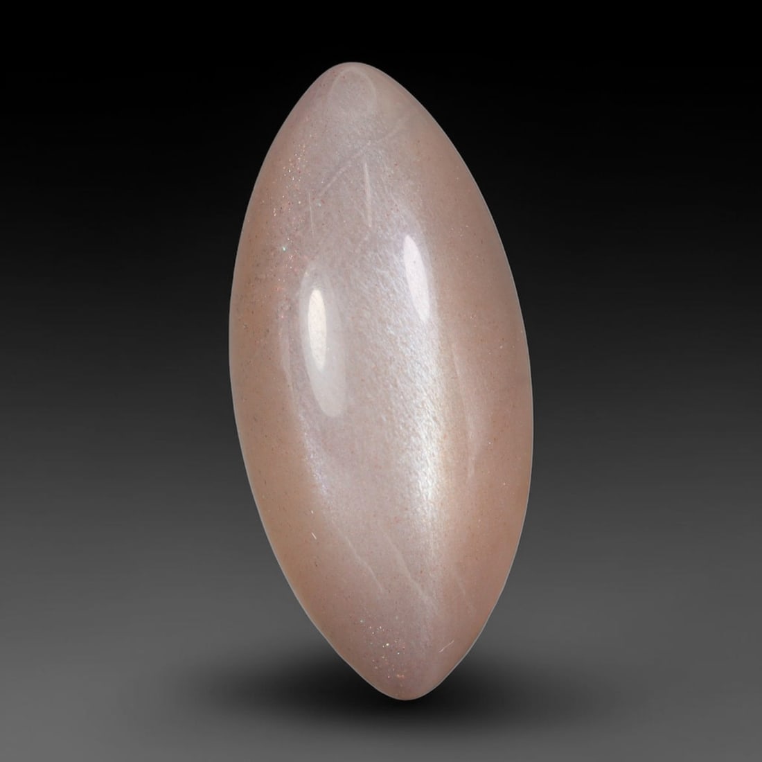 9.70 Carats Natural Ceylon Peach Fibrous Inclusion Moonstone Marquise Cabochon Loose Gemstone, 85WS: This soft peach blush Ceylon moonstone marquise cabochon features a translucent warm pale feldspar base woven with fine fibrous mineral veils and subtle glittering micro-sparkle flecks within the matr